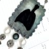 close-up black resin lung steam punk inspired necklace with white, black and clear beads