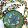 Iridescent Handmade Resin Snowflake in Brass Hobnail Bezel