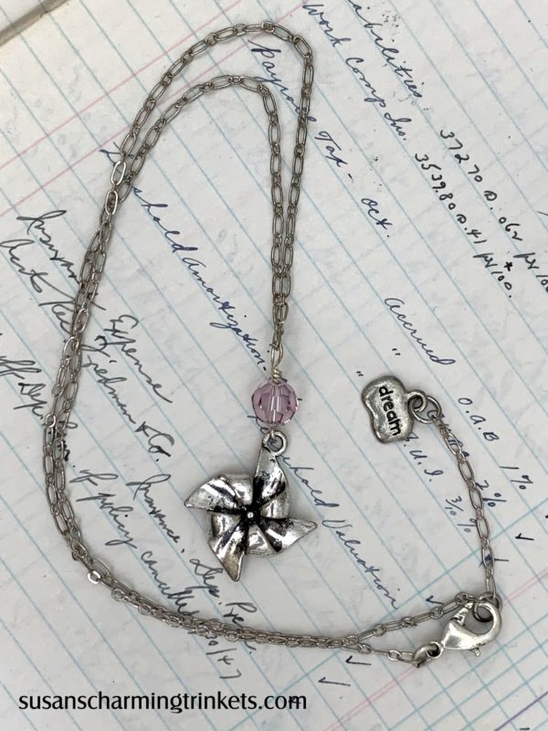 Pinwheel charm necklace with pink bead